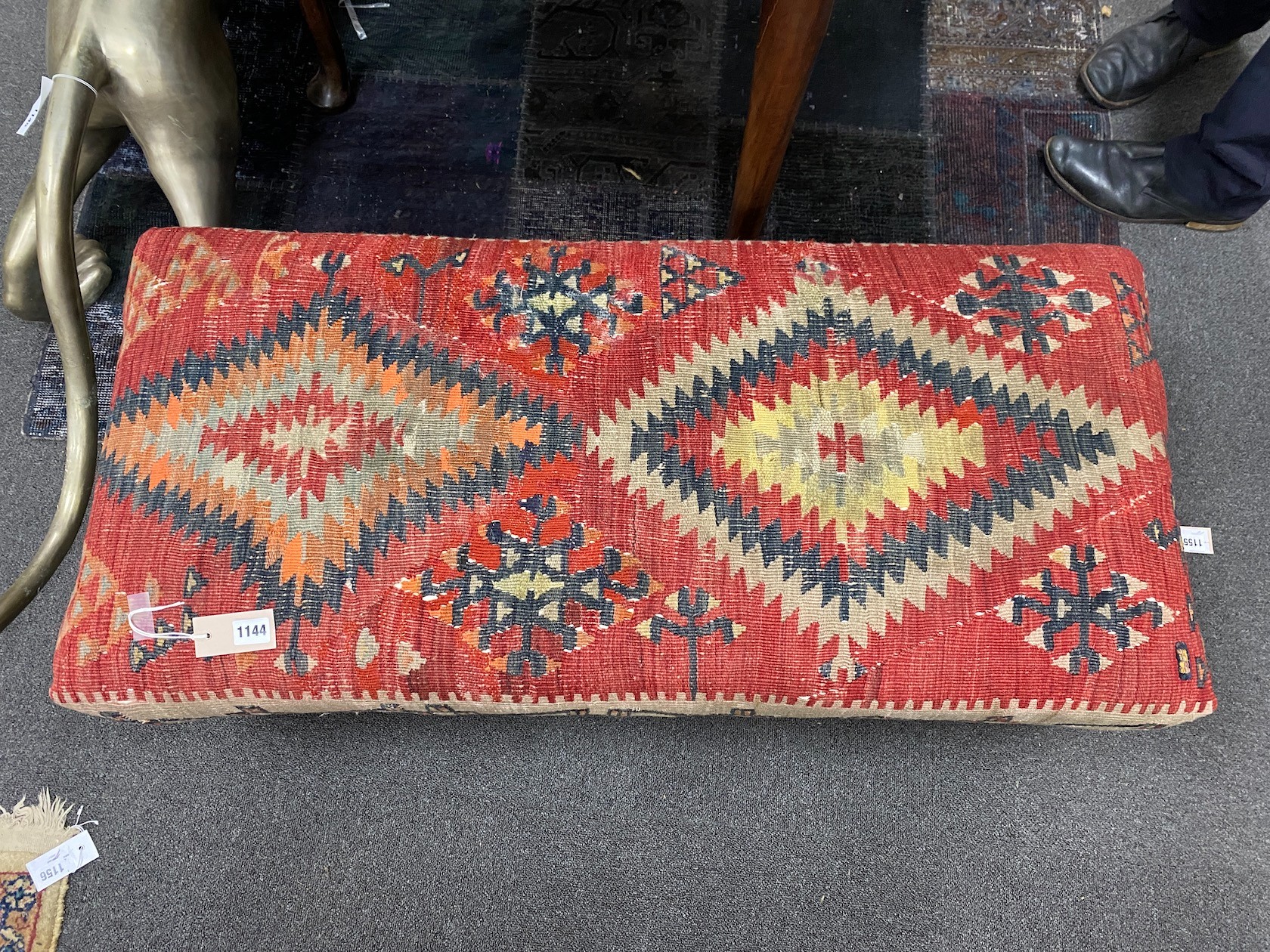 A Kelim covered long foot stool, length 108cm, depth 50cm, height 35cm